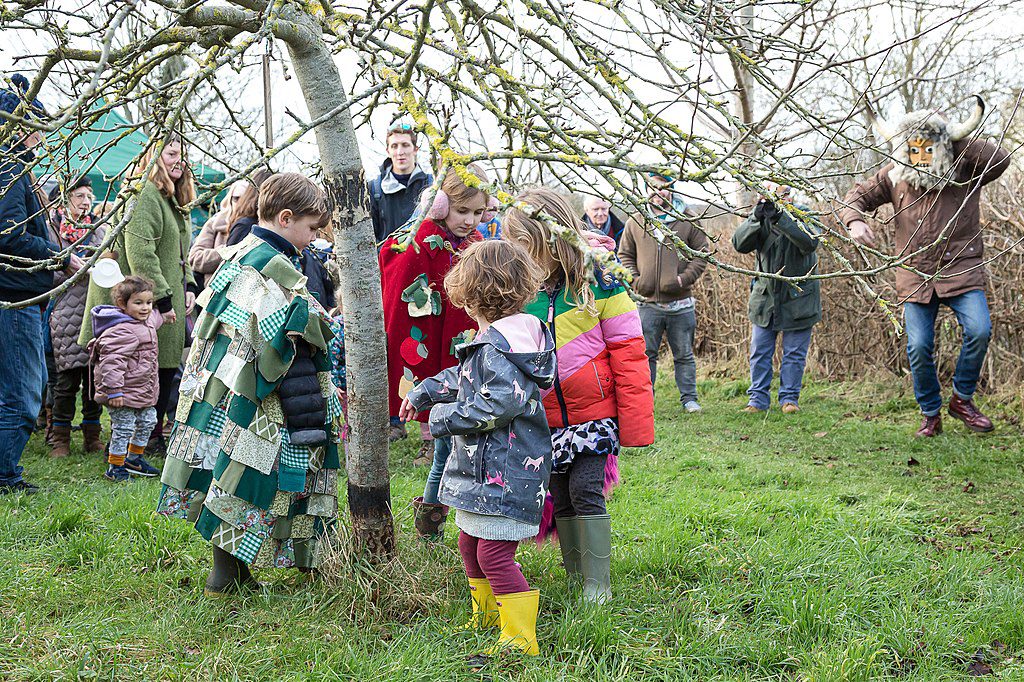 Children in Bridport, Dorset, wassailing in a community orchard